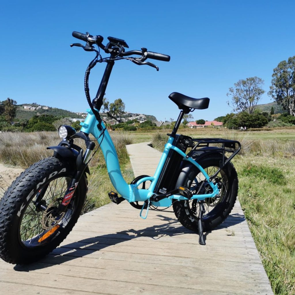 blue electric bicycle driving on difficult terrain