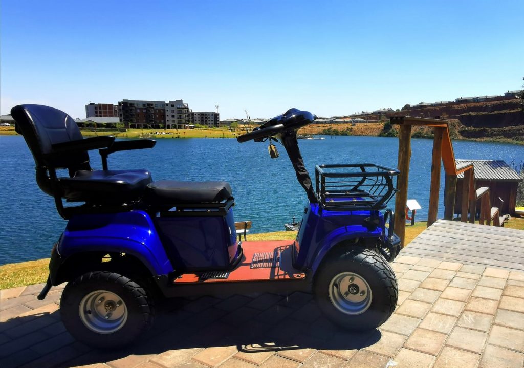 blue electric four wheeler mobility vehicle at the see