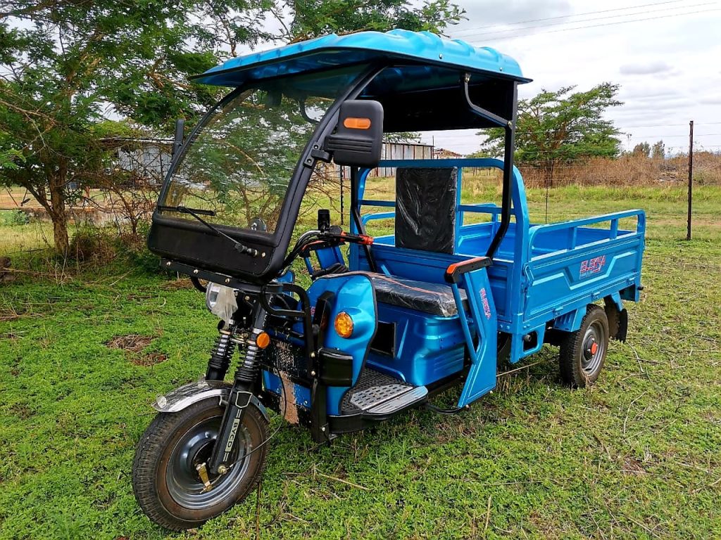 blue three wheel bike bakkie Impi H21 with roof on a farm